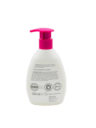 White bottle with pink pump on a white background