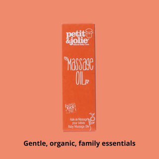 Box of petit & jolie baby massage oil on a peach background