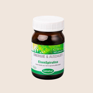 Vitamin supplement bottle with green label on a beige background
