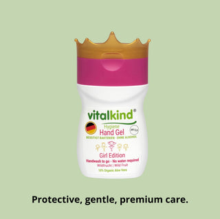 Vitalkind hand gel with a pink cap on a green background