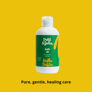 Bottle of Petit & Jolie bath oil on a yellow background