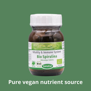 Bottle of Bio Spirulina tablets with a green background