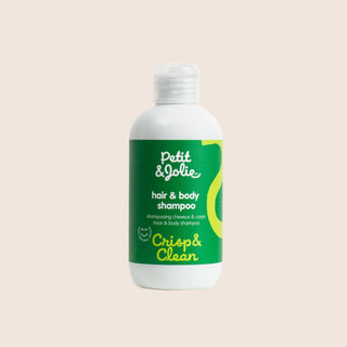 Bottle of Petit & Jolie hair and body shampoo on a beige background