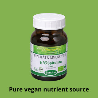 Bottle of Sanatur BIOSpirulina on a green background with text about it being a pure vegan nutrient source.