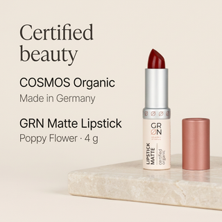 GRN Poppy Flower matte lipstick 4 g on a pale stone podium with COSMOS Organic and Made in Germany text.
