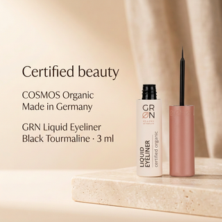 GRN Liquid Eyeliner Black Tourmaline 3 ml, COSMOS Organic and Made in Germany, on a pale stone podium.